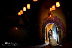 a bride and groom standing in the doorway to their wedding reception at disney's animal kingdom