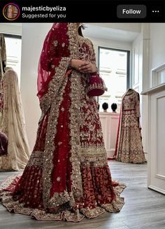 a woman in a red and gold bridal gown