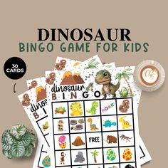 the dinosaur game for kids is shown on top of a table next to a cup of coffee