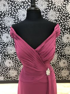 a dress on a mannequin in front of a wall