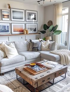 a living room filled with furniture and pictures on the wall above it's coffee table