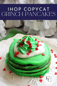 a stack of green pancakes with white frosting and sprinkles on top