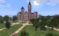 a large building with a clock tower in the middle of it's front yard