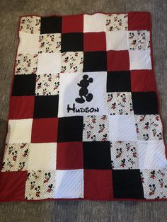 a mickey mouse quilt on the floor