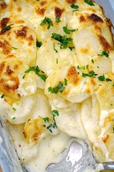 a casserole dish with cheese and garnished potatoes