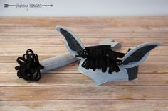 a black and white object sitting on top of a wooden table next to a pair of scissors