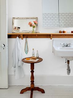 a bathroom with a table, sink and mirror