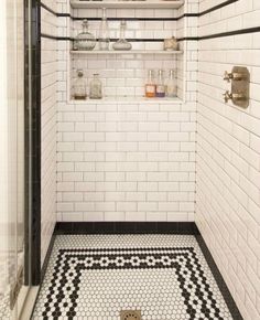 a black and white tiled shower with shelves