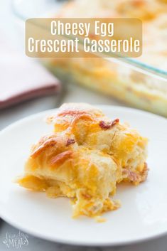 cheesy egg crescent casserole on a white plate next to a baking dish