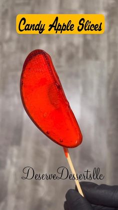 candy apple slices on a stick with the words candy apple slices above it in black gloves