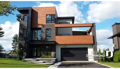 a large modern house with lots of windows and wood trimmings on the front