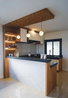 a kitchen with wooden cabinets and black counter tops, along with an island in the middle