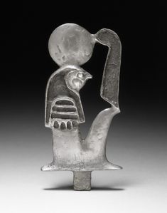 an egyptian glass figurine with a bird on it's head