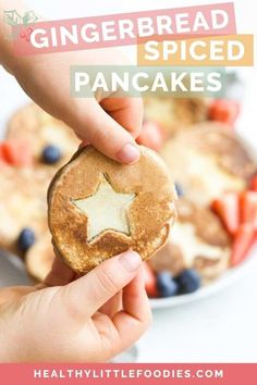 a person holding up a piece of bread with a star shaped cookie on it and text overlay that reads, gingerbread spiced pancakes