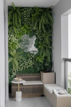 a living room with green walls and plants on the wall