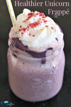 a purple drink with whipped cream and sprinkles