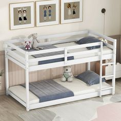 a white bunk bed with blue sheets and pillows on it in a child's room