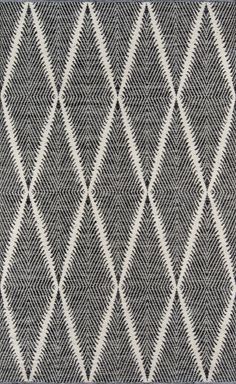 a black and white rug with diamond shapes on the front, in various shades of grey