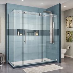 a bathroom with a glass shower door and blue tiles on the walls, along with a white rug