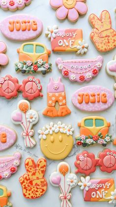 many decorated cookies are displayed on a table