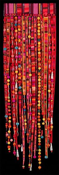 an art work with many colorful beads hanging from it's sides and fringes