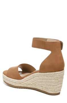 Experience ultimate style and arch support with every step you take in this comfortable espadrille wedge sandal complete with a dainty ankle strap. 2.75" heel; 1" platform Adjustable ankle strap with hook-and-loop closure Cushioned insole Open toe Espadrille wedge heel PU upper/synthetic lining and sole Imported Adjustable Wedge Sandals With Removable Insole, Casual Adjustable Ankle Strap Wedge Sandals, Adjustable Espadrille Wedge Sandals, Adjustable Closed Toe Wedge Sandals With Cushioned Footbed, Adjustable Cushioned Closed Toe Wedge Sandals, Adjustable Open Toe Espadrille Wedge Sandals, Spring Wedge Sandals With Adjustable Removable Insole, Spring Adjustable Wedge Heel Sandals, Adjustable Wedge Sandals With Arch Support