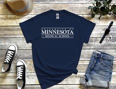 Customized Medical School Shirt, Custom Medicine School TShirt, Personalized University Tee Shirt Faculty Program Name, Unisex size for Men and Women size S, M, L, XL, 2XL, 3XL, 4XL and 5XL available in 8 color: Black, Navy, Sport Grey, Red, White, Royal Blue, Irish Green & Military Green. 🔆 I'M BESIDE YOU  If you still need request, personalization or customization? feel free to send me message. if yoou still need another color? contact me for confirmation availability. TSHIRT DETAIL 🔹5.3 oz College Short Sleeve Shirt With Logo Print, Casual Short Sleeve Shirt With Logo Print, Medicine School, University Of Evansville, University Tees, College T Shirts, Medical School, School Shirts, Military Green