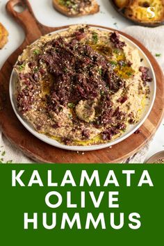 kalamata olive hummus on a wooden cutting board