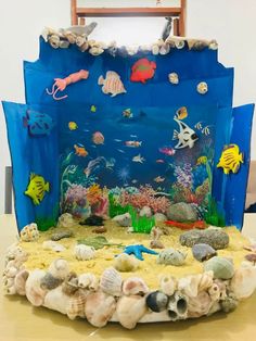 a cake made to look like an ocean scene with fish and corals on it