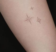 a woman's arm with three small stars on the back of her left arm