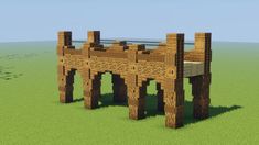 a wooden bridge made out of bricks in the middle of a field