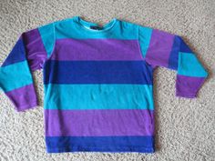 Great item.  Vintage.  Has that late 80's/early 90's look and colors.  This is a combination of a shirt and a sweatshirt.  Material is soft and almost has a terry cloth texture, or something like that.   78% cotton/22% polyester. Women's medium (appears fairly large for a medium, but probably is supposed to be worn big. See measurements). pit to pit: 23" top of shoulder to bottom front: 27" Good condition.  Some light signs of use. Retro Long Sleeve Color Block Tops, Retro Color Block Long Sleeve Tops, 90s Inspired Long Sleeve Winter Tops, Purple 90s Style Tops For Fall, Purple 90s Style Top For Fall, 90s Inspired Long Sleeve Cotton Top, Unisex Long Sleeve Winter Tops, 90s Style Multicolor Long Sleeve Sweatshirt, Retro Long Sleeve Purple Sweatshirt