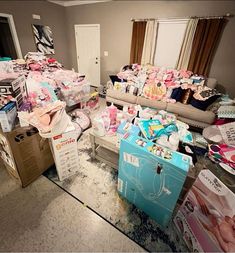 a living room filled with lots of clutter and boxes on top of the floor