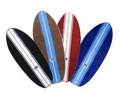 four surfboards are lined up in a row on a white background and one is blue, the other is brown