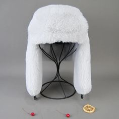 a white fur hat sitting on top of a table