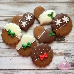 decorated cookies are arranged on a wooden surface