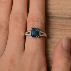 It is a London blue topaz ring. The main stone is 7 mm*9 mm emerald cut.weight about 3.26 carats. The basic metal is sterling silver and plated with rhodium. To change the metal to a solid gold (white/rose) or platinum is also available, please ask for a quotation if you want. You can also go to my shop Home for more elegant rings: https://www.etsy.com/shop/godjewelry?ref=hdr_shop_menu London blue topaz is November birthstone More London blue topaz rings: https://www.etsy.com/shop/godjewelry?ref Silver Emerald-cut Topaz Ring With Gemstone Accents, Elegant Octagon Topaz Promise Ring, Elegant Topaz Ring With Baguette Cut, Classic Emerald-cut Topaz Ring In Sterling Silver, Elegant Baguette Cut Topaz Ring, Sapphire Topaz Emerald Cut Promise Ring, Classic Blue Topaz Ring With Rectangular Stone, Emerald Cut Topaz Ring With Gemstone Accents, Gift, Elegant Topaz Rings With Rectangular Stone