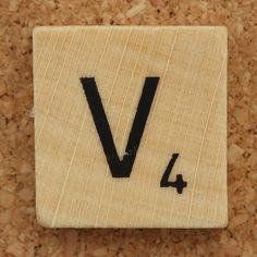 a wooden block with the letter v on it