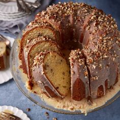 a bundt cake with chocolate frosting and nuts on top