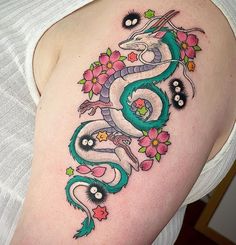 a woman with a dragon tattoo on her shoulder