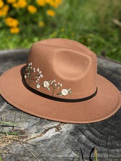 a brown hat sitting on top of a tree stump