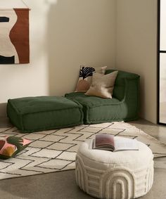 a green couch and ottoman in a room