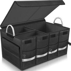 an open black storage box with four compartments and two handles on each side, in front of a white background