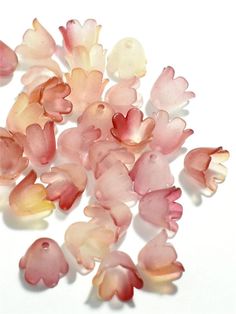 small pink and yellow flowers on a white surface