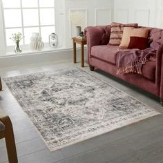 a living room with a pink couch and rug