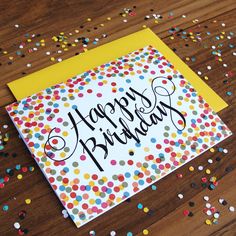 a happy birthday card with confetti on it