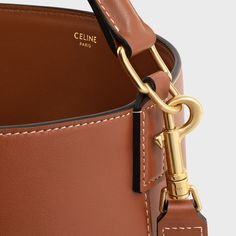 MEDIUM LOUISE BAG IN SMOOTH CALFSKIN - TAN | CELINE High-end Bucket Bag With Detachable Strap For Travel, High-end Travel Bucket Bag, High-end Bucket Bag Satchel With Detachable Strap, High-end Bucket Bag With Detachable Strap Satchel, High-end Brown Shoulder Bag With Adjustable Strap, High-end Brown Bucket Bag For Everyday Use, High-end Double Handle Bucket Bag, High-end Bucket Bag With Detachable Handle, High-end Bucket Bag Tote With Detachable Strap