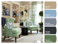 a living room filled with furniture and lots of green color scheme in shades of blue