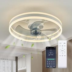 a ceiling fan and remote control in a living room