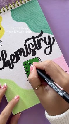 a person is writing on a book with the word'elementary'in black ink